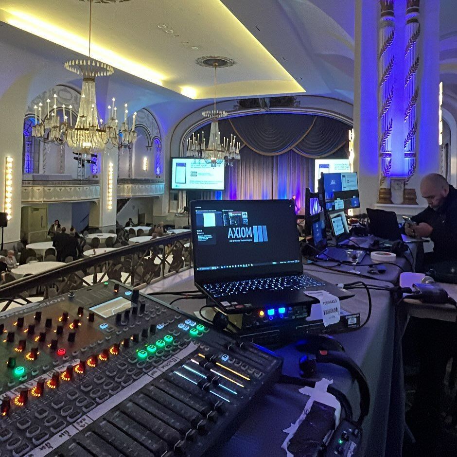 Mixing console overlooking a chandelier ballroom