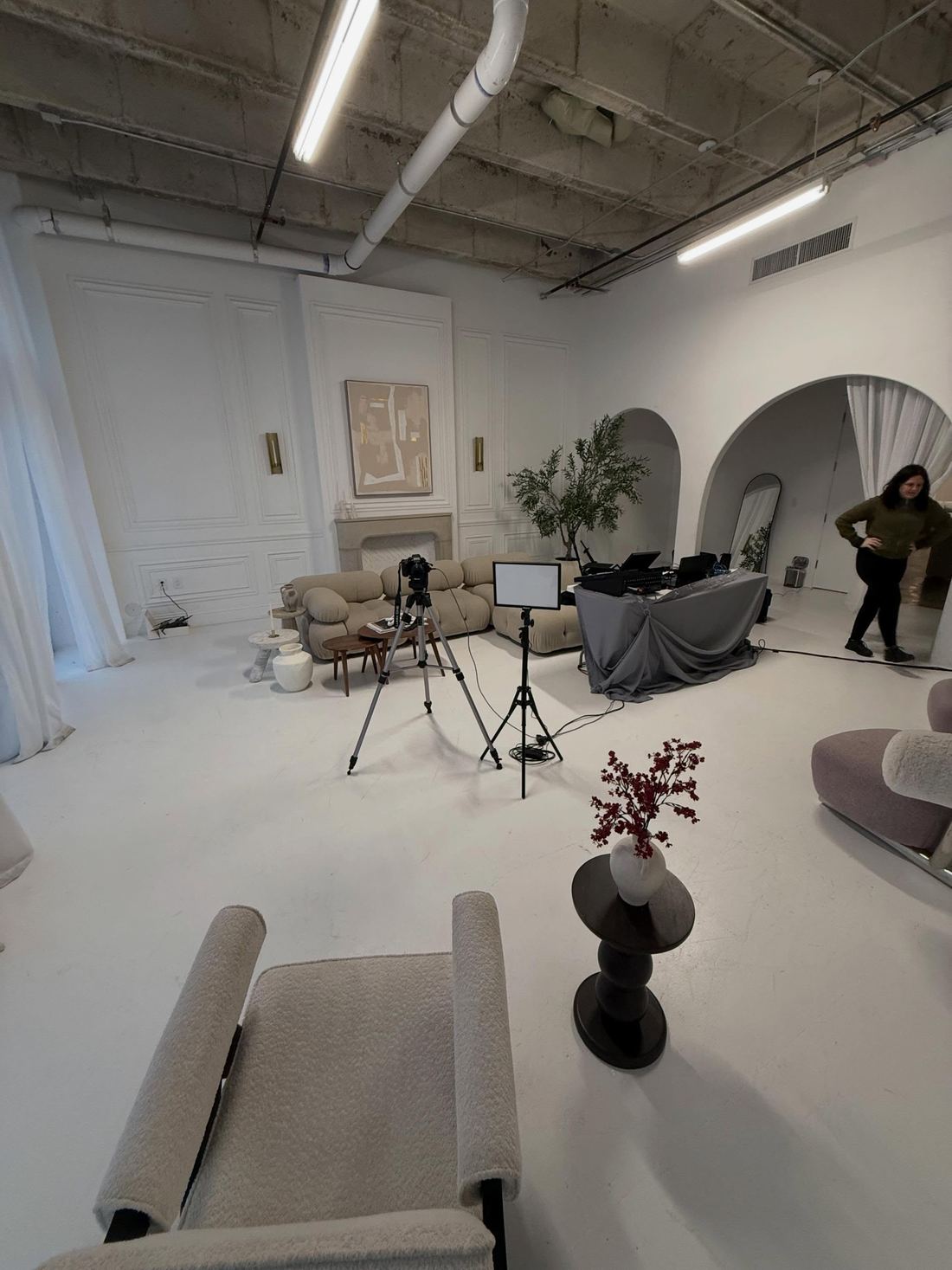 Camera, lighting and interview setup in a white studio